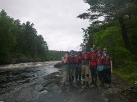The group smiling after a day of whitewater paddling at the Basswood river